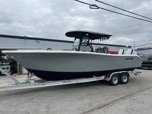 Sea Pro 292 DLX 2025 Sea Pro 292 boat on trailer, gray hull, overcast sky.