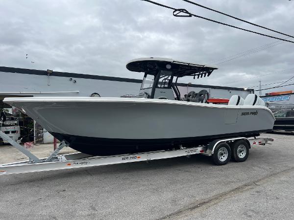 Sea Pro 292 DLX 2025 Sea Pro 292 boat on trailer, gray hull, overcast sky.