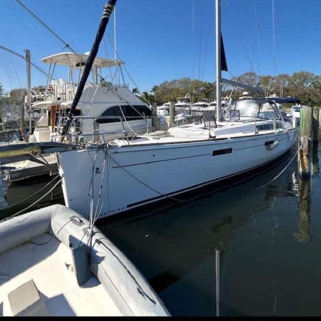 Beneteau Oceanis 45 2016 Beneteau Oceanis 45 sailboat docked at a marina under clear blue skies.