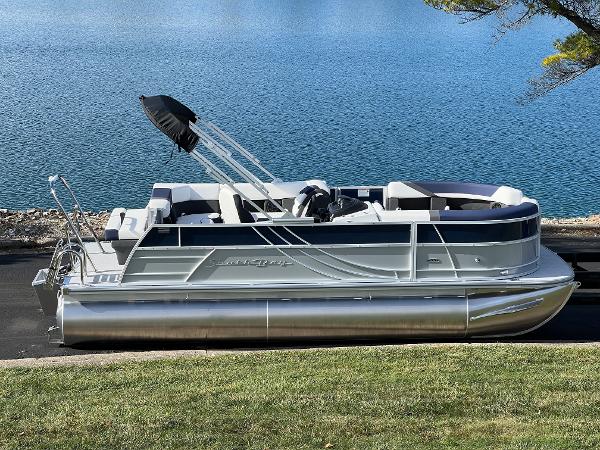 South Bay S 220CR2 2025 South Bay S 220CR2 pontoon boat by a serene lake.