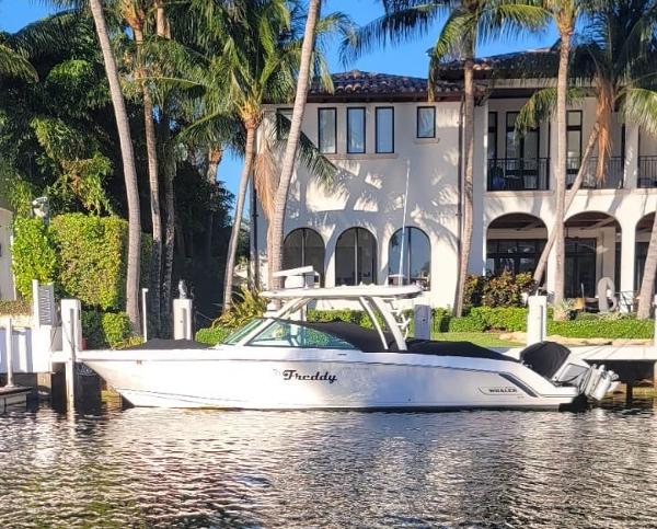 Boston Whaler 320 Vantage 2021 Boston Whaler 320 Vantage boat docked by a luxurious waterfront home.