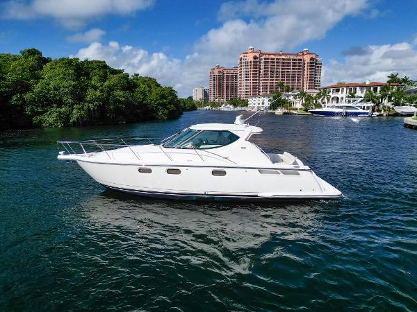 Tiara Yachts 3900 Sovran 2008 Tiara Yachts 3900 Sovran cruising on a scenic waterway with lush greenery and buildings.