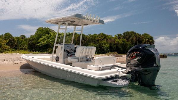 ShearWater 23LTZ 2025 ShearWater 23LTZ boat on a sandy beach with Yamaha outboard motor.