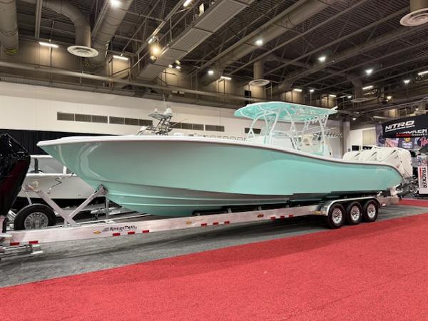 Yellowfin 36 Offshore 2024 Yellowfin 36 Offshore boat displayed indoors on a trailer with red carpet.