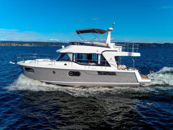 Beneteau Swift Trawler 41 2024 Beneteau Swift Trawler 41 cruising on open water under clear blue skies.