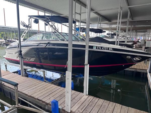 Cobalt 242 WSS 2011 Cobalt 242 WSS boat docked in a marina, featuring sleek black design.