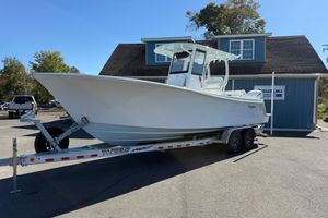 Pair Customs 28 Center Console 2025 Pair Customs 28 Center Console boat on trailer, parked outside a blue building.