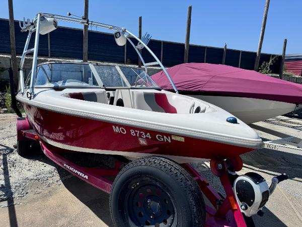 Moomba Outback LSV 2003 Moomba Outback LSV boat on trailer, red and white, parked outdoors.