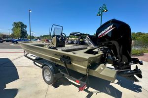 Tracker Grizzly 1860 CC 2026 Tracker Grizzly 1860 CC boat with Mercury engine on trailer, parked outdoors.