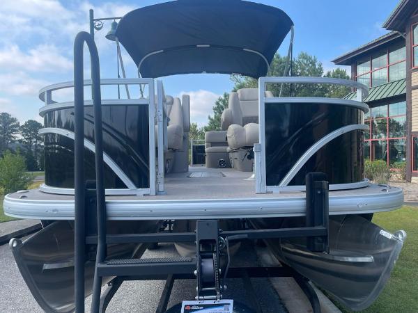 Sun Tracker Sportfish 24 XP3 2025 Sun Tracker Sportfish 24 XP3 pontoon boat on trailer, black exterior, parked outdoors.