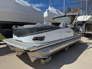 Tahoe Pontoon LTZ Quad Lounger 2025 Tahoe Pontoon LTZ Quad Lounger, sleek design, docked outdoors under clear sky.
