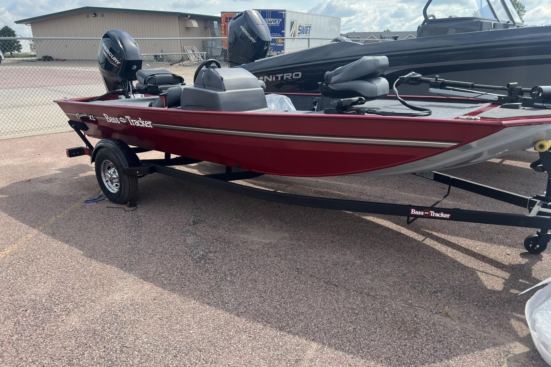 Tracker Bass Tracker Classic XL 2025 Tracker Bass Tracker Classic XL boat in red, parked on a trailer outdoors.