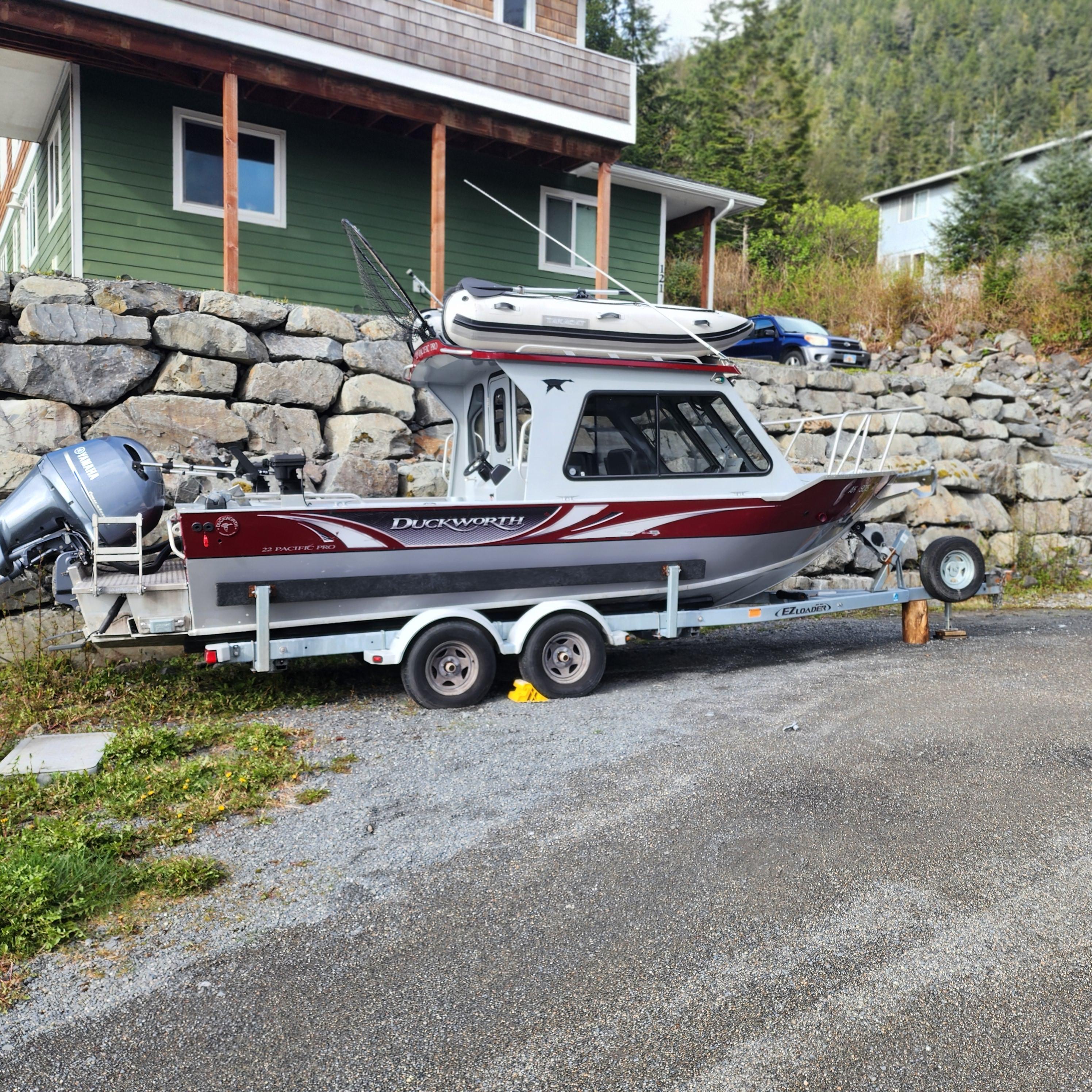 Duckworth Pacific Pro 2018 Duckworth Pacific Pro boat on trailer, parked near stone wall and green house.