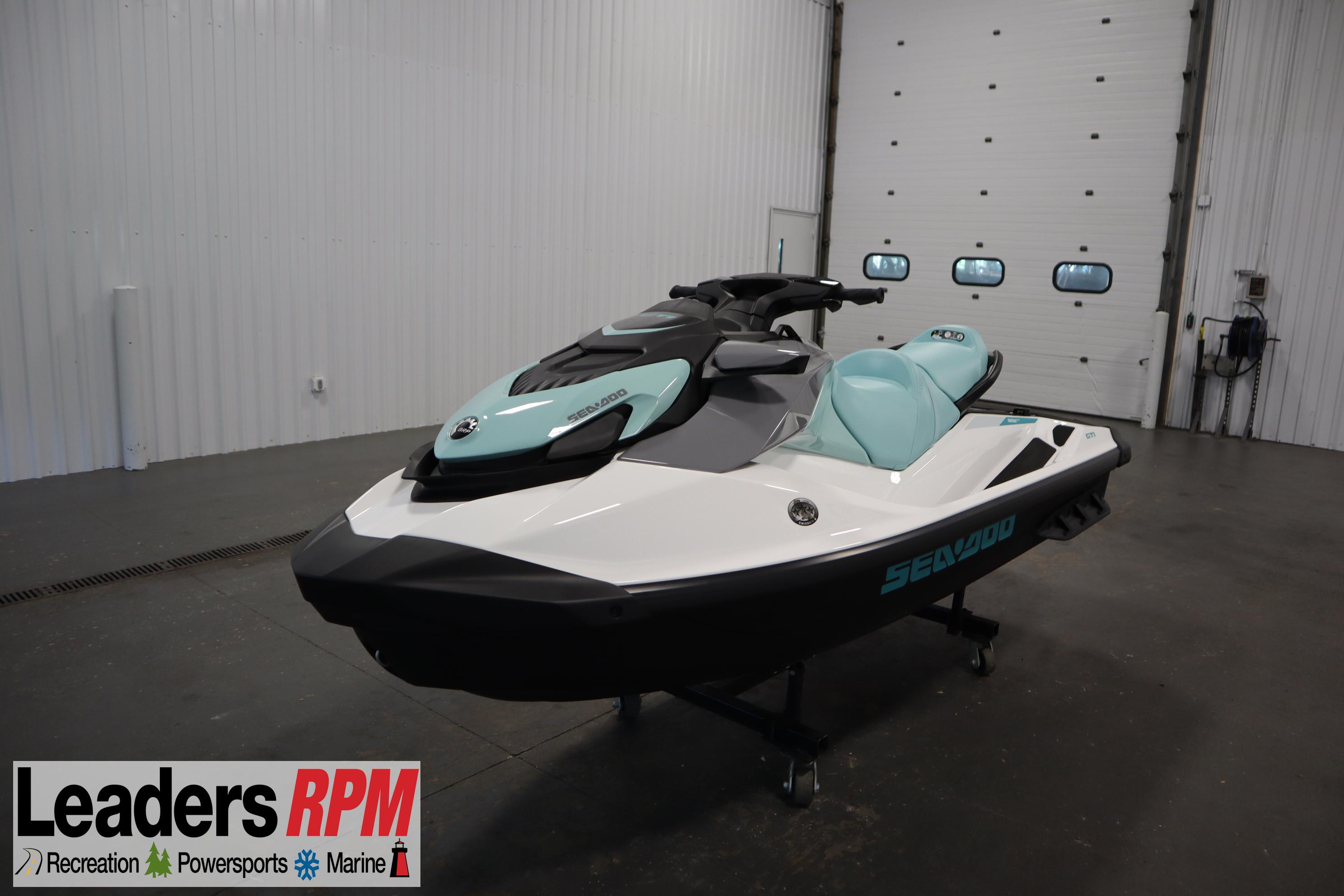 Sea-Doo GTI 130 2025 Sea-Doo GTI™ 130 jet ski in showroom, featuring sleek design and mint green accents.