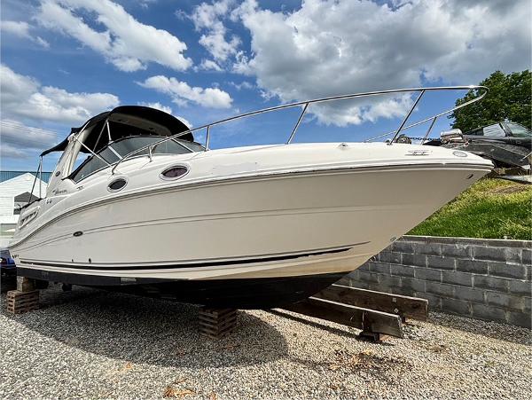 Sea Ray 260 Sundancer 2007 Sea Ray 260 Sundancer boat on dry dock under a partly cloudy sky.