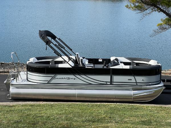 South Bay 222RS 2025 South Bay 222RS pontoon boat by a serene lake.