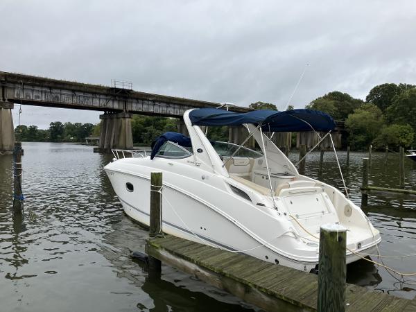 Sea Ray 280 Sundancer 2012 Sea Ray 280 Sundancer docked by a bridge on a cloudy day.