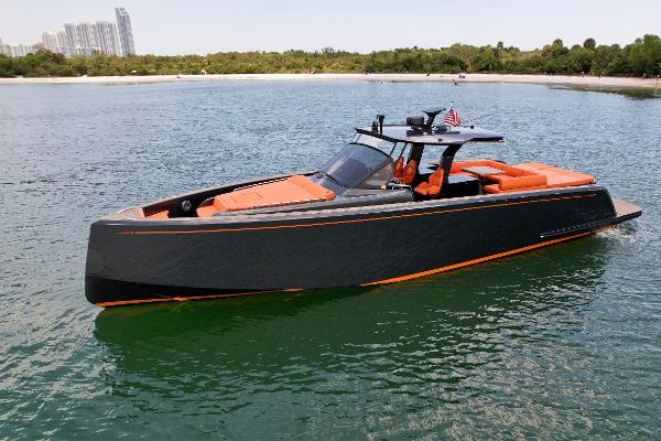 Pardo Yachts 50 2023 Pardo Yachts 50 in water, sleek design, orange accents, near shoreline.
