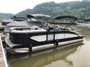 Barletta Cabrio 22UC 2024 Barletta Cabrio 22UC pontoon boat docked on a calm lake.