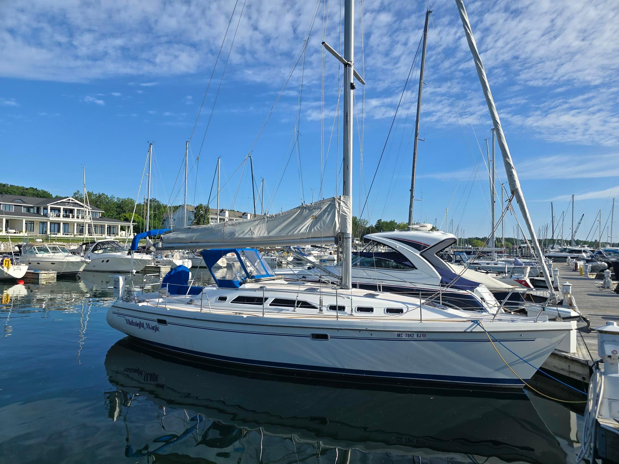 Catalina 380 Special Catalina 380 Special 1997 sailboat docked at marina under blue sky.
