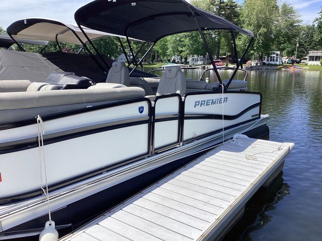 Premier 230 Intrigue RF 2024 Premier 230 Intrigue RF pontoon boat docked on a serene lake.