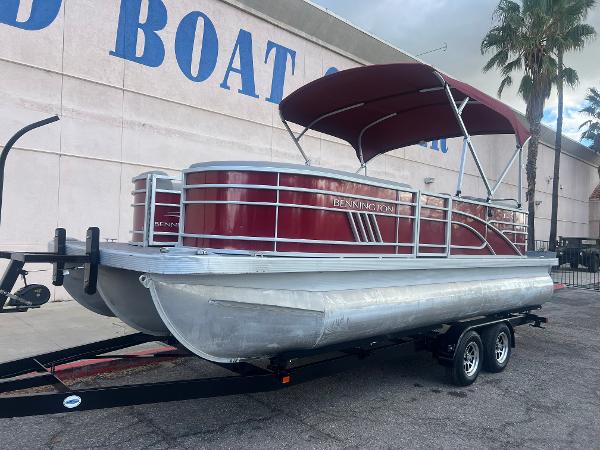 Bennington 22LSR 2021 Bennington 22LSR pontoon boat on trailer with red canopy.