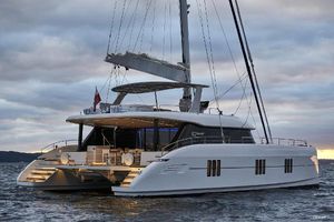 Sunreef 60 Luxurious 2018 Sunreef 60 yacht sailing at sunset, showcasing elegant design and spacious deck.