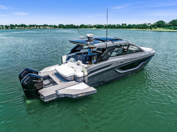 Cruisers Yachts 42 GLS OB 2023 Cruisers Yachts 42 GLS OB on serene water, showcasing sleek design and powerful outboard engines.