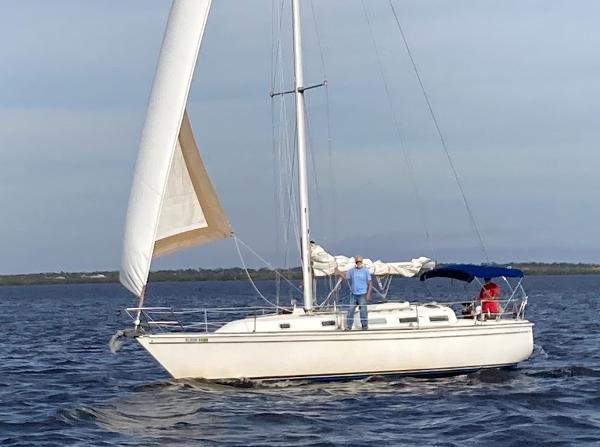 Pearson 36-2 1987 Pearson 36-2 sailboat on open water with two people onboard.