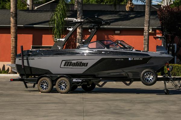 Malibu Wakesetter 22 LSV 2021 Malibu Wakesetter 22 LSV boat on trailer, parked outdoors.