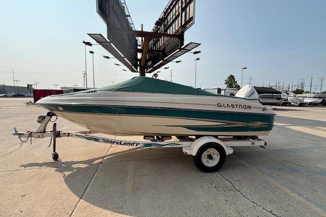 Glastron GX 180 2000 Glastron GX 180 boat on trailer in parking lot, covered and ready for transport.