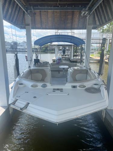 NauticStar 203 SC 2017 NauticStar 203 SC boat docked under a covered marina with blue canopy.
