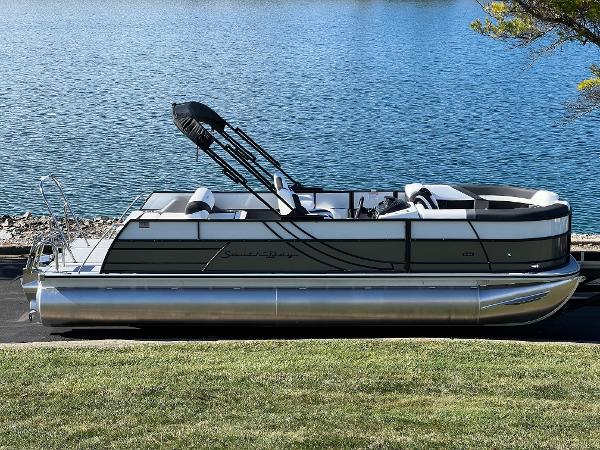 South Bay S 224 UL 2025 South Bay S 224 UL pontoon boat by a serene lake.