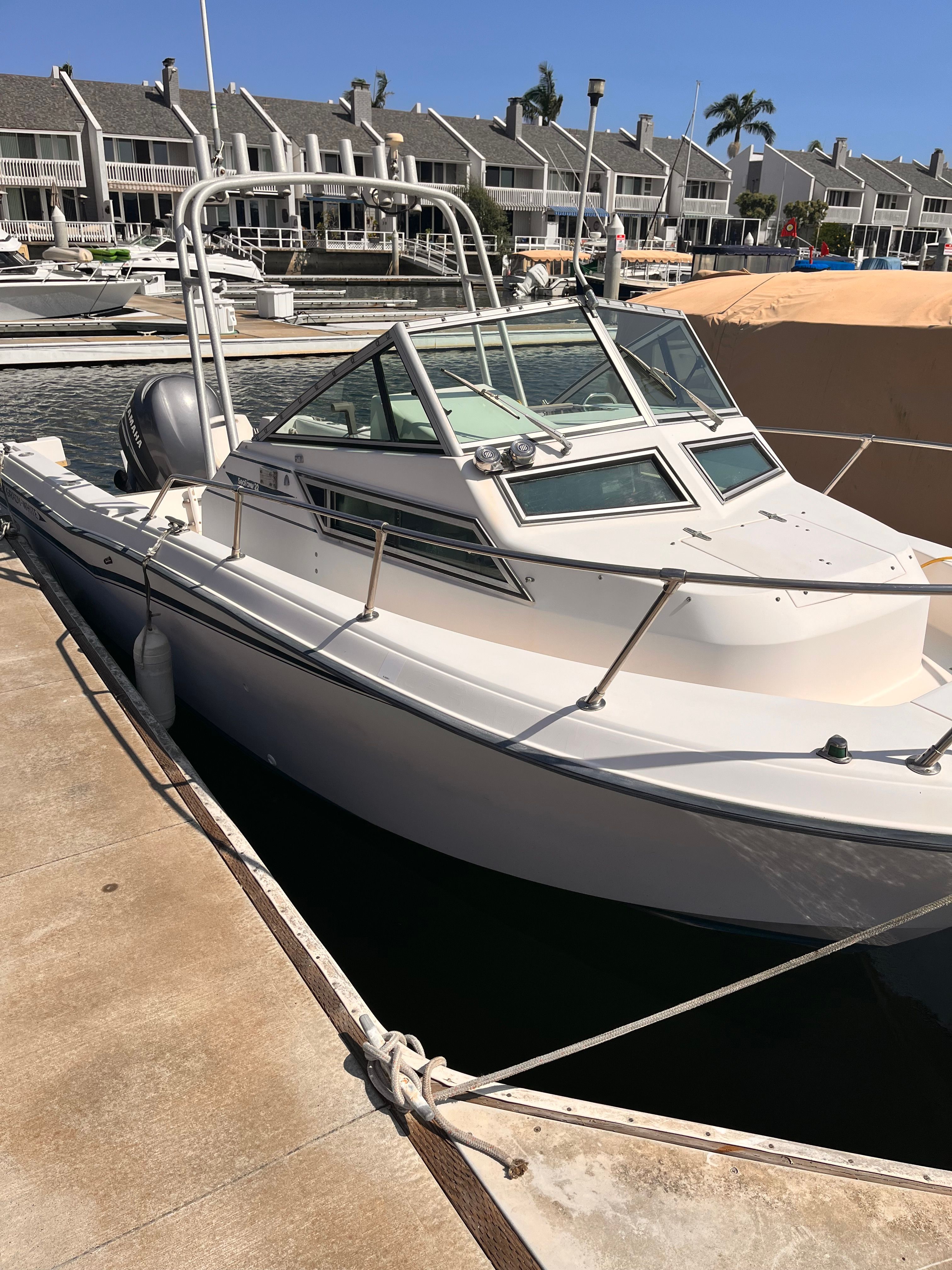 Grady-White Seafarer 1991 Grady-White Seafarer boat docked at a marina with waterfront homes.