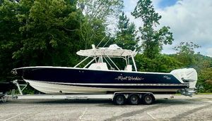 SeaVee 390B 2008 SeaVee 390B boat on trailer, parked outdoors with lush green trees in the background.