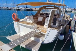 Dufour 460 Grand Large 2016 Dufour 460 Grand Large yacht docked at marina with open cockpit and sunshade.