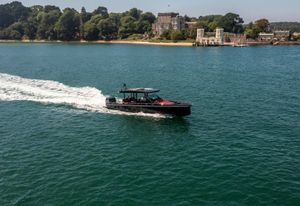 Axopar 37 Sun Top 2017 Axopar 37 Sun Top cruising on a scenic waterway near a historic estate.