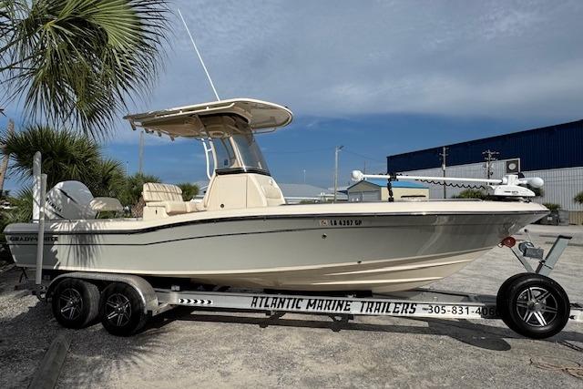 Grady-White 251 Coastal Explorer 2021 Grady-White 251 Coastal Explorer boat on trailer, parked outdoors.