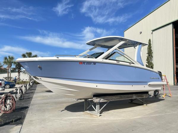 Chaparral 280 OSX 2022 Chaparral 280 OSX boat on display outdoors, blue hull, clear sky background.