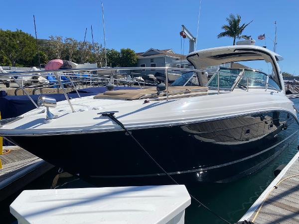 Sea Ray 350 Sundancer 2016 Sea Ray 350 Sundancer docked at marina under clear blue sky.