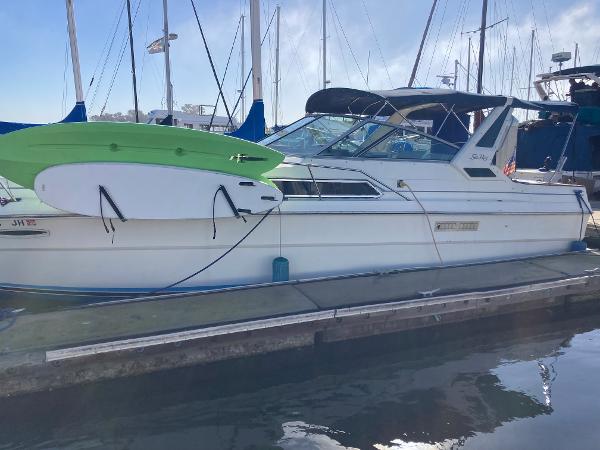 Sea Ray 340 Express Cruiser 1986 Sea Ray 340 Express Cruiser docked with paddleboard attached.
