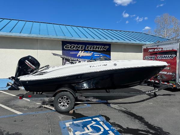 Tahoe T18 2025 Tahoe T18 boat on trailer at dealership, blue sky background.