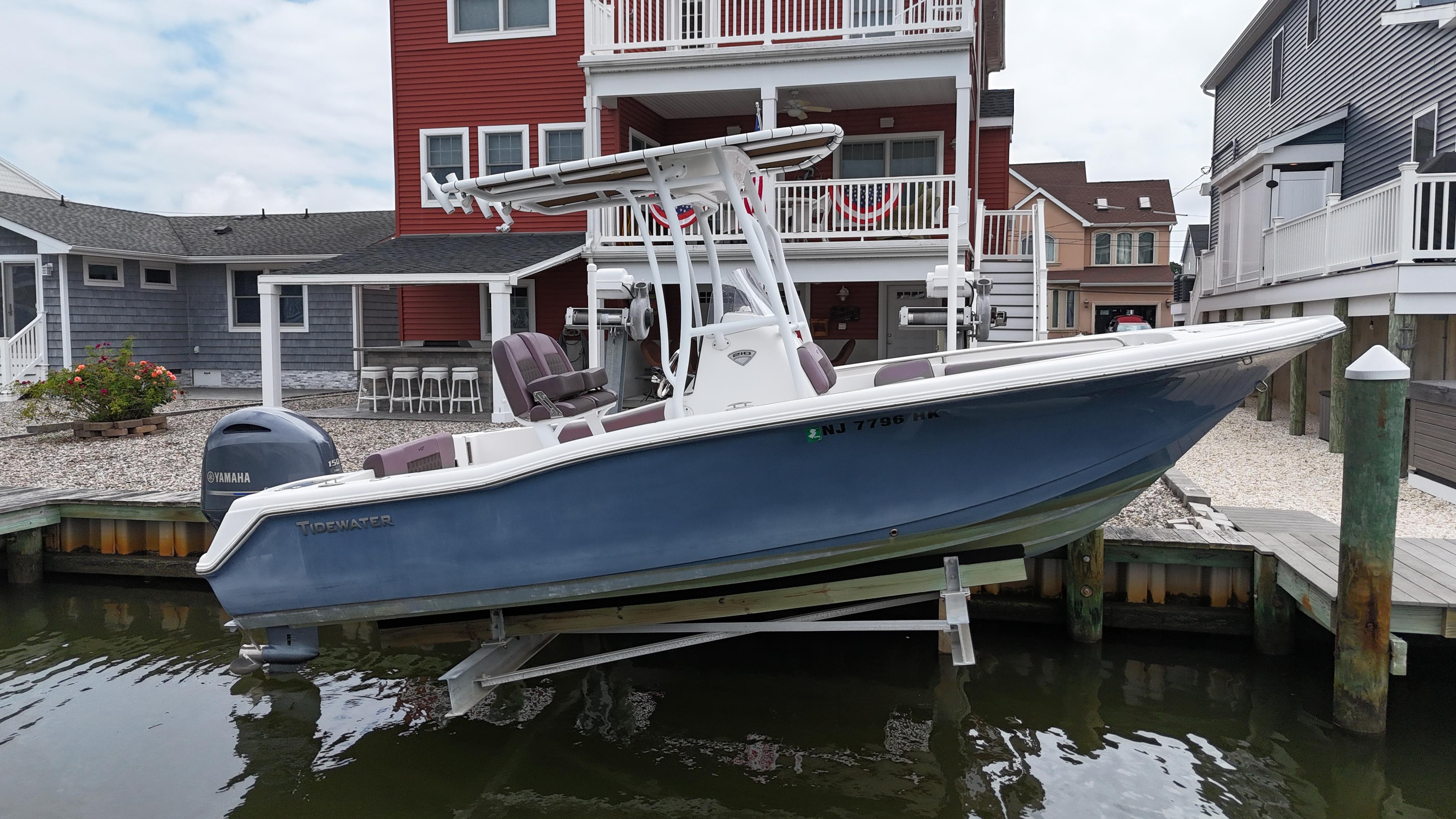 Tidewater 210 CC 2017 Tidewater 210 CC boat docked near waterfront homes.