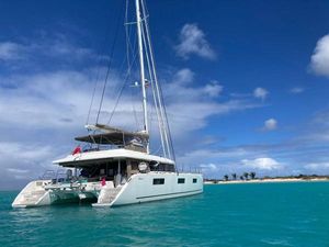 Lagoon 620 2019 Lagoon 620 catamaran anchored in turquoise waters under a clear blue sky.