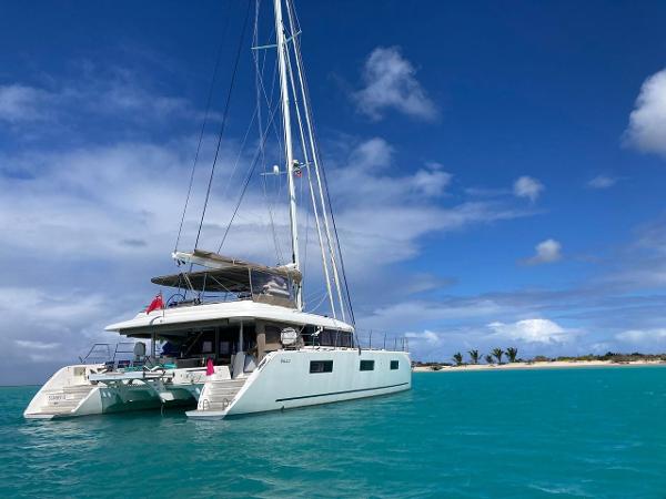 Lagoon 620 2019 Lagoon 620 catamaran anchored in turquoise waters under a clear blue sky.