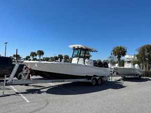 Caymas 281 HB 2024 Caymas 281 HB boat on trailer in sunny parking lot with palm trees.