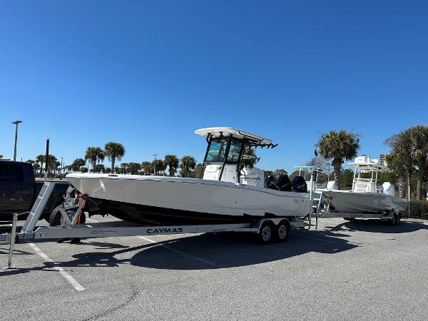 Caymas 281 HB 2024 Caymas 281 HB boat on trailer in sunny parking lot with palm trees.