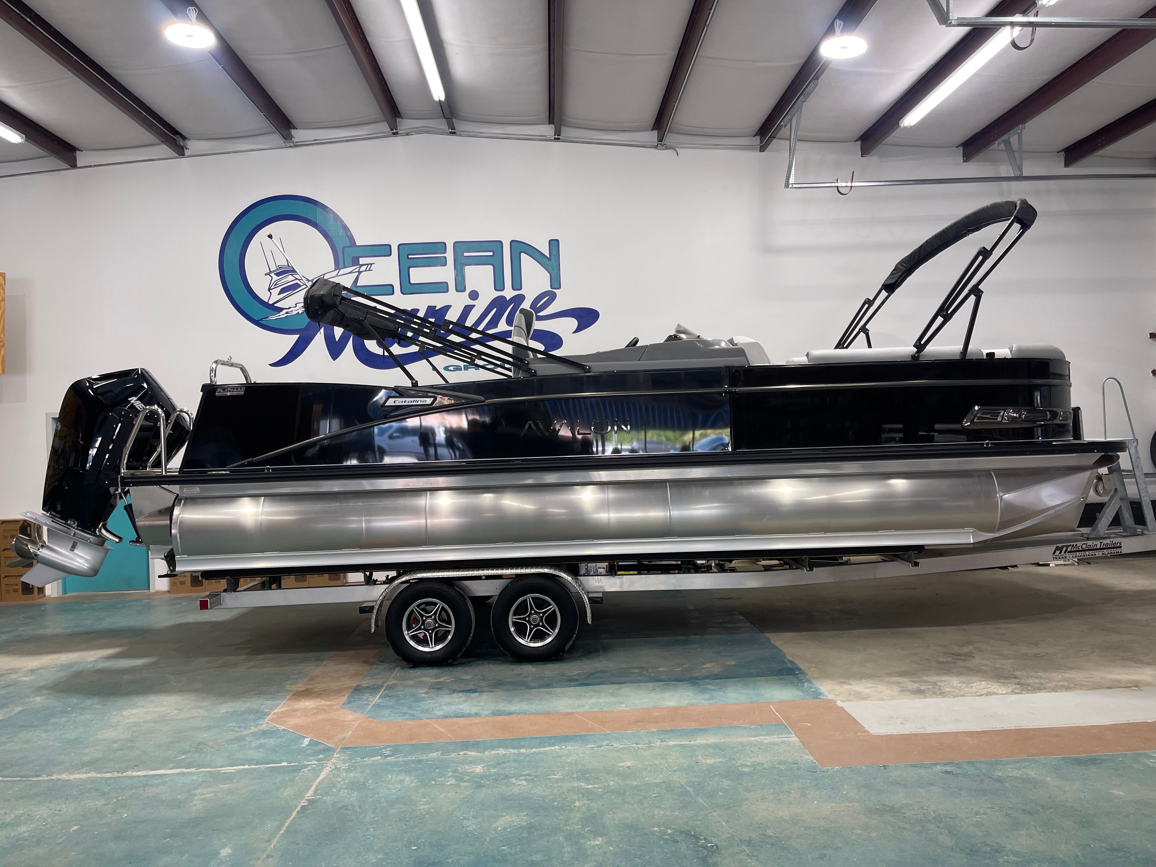 Avalon CAT VRB25T 2025 Avalon CAT VRB25T pontoon boat on trailer in showroom.