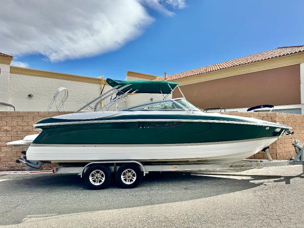 Cobalt 282 2008 Cobalt 282 boat on trailer, green and white, parked outdoors.