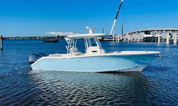 Cobia 301 Center Console 2021 Cobia 301 Center Console boat on water near a marina.